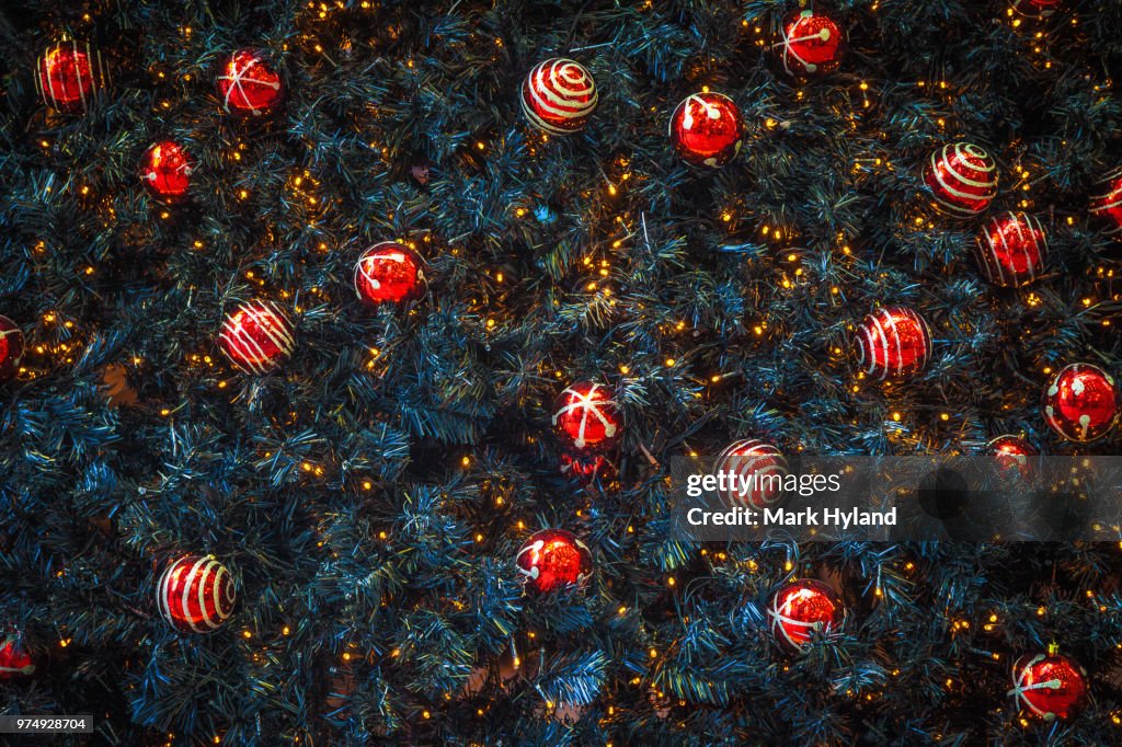 Red christmas decorations on christmas tree