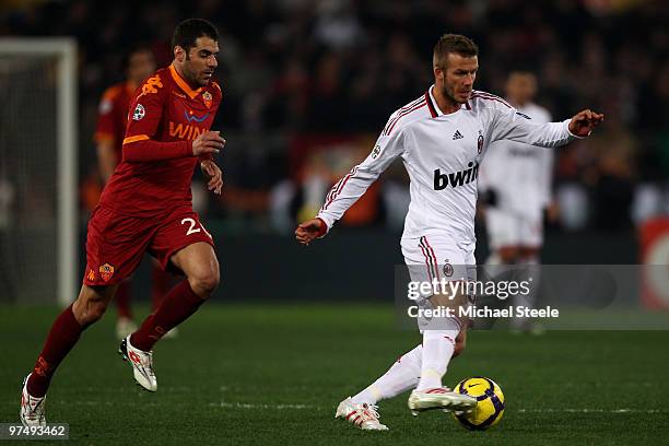 David Beckham of Milan watched by Simone Perrotta during the Serie A match between AS Roma and AC Milan at Stadio Olimpico on March 3, 2010 in Rome,...