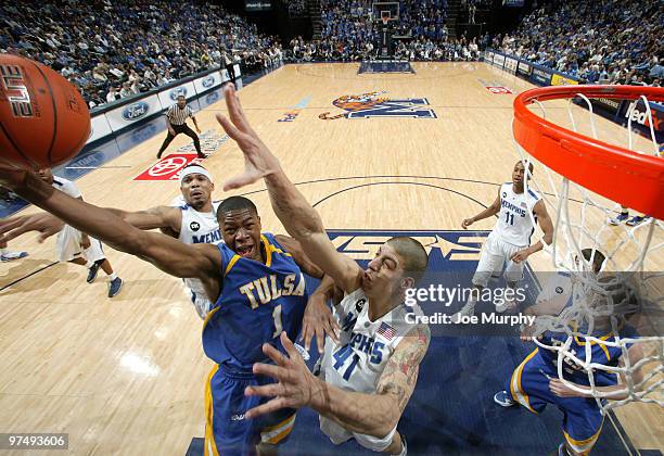 Ben Uzoh of the Tulsa Golden Hurricane drives to the basket for a layup between Roburt Sallie and Angel Garcia of the Memphis Tigers on March 6, 2010...