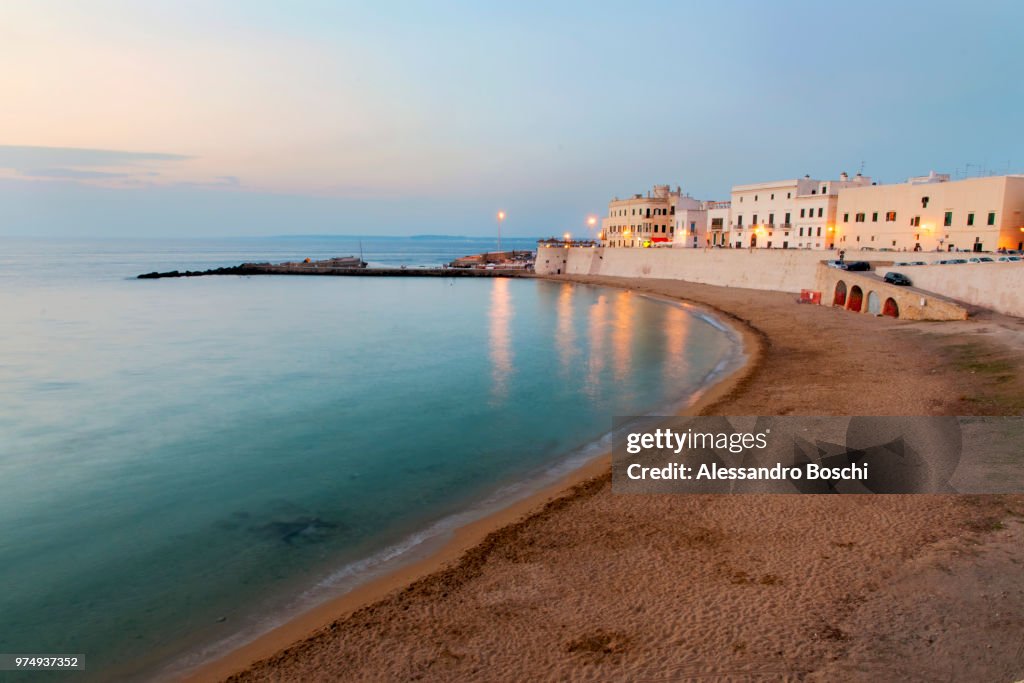 Beach and waterfront buildings at dusk, Lecce, Apulia, Italy