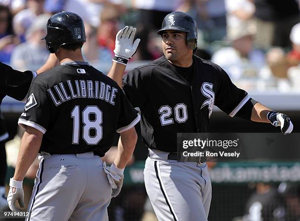 Carlos Quentin celebrates with Brent Lillibridge of the Chicago White Sox after hitting his second home run of the game against the Chicago Cubs on...