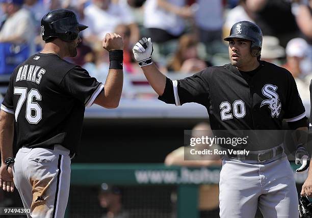 Carlos Quentin celebrates with Jordan Danks of the Chicago White Sox after hitting the first of 2 home runs against the Chicago Cubs on March 6, 2010...