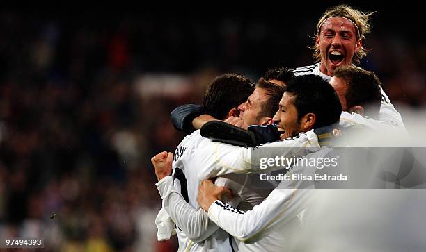 Rafael Van der Vaart of Real Madrid celebrates his goal with Ezequiel Garay and Guti during the La Liga match between Real Madrid and Sevilla at...