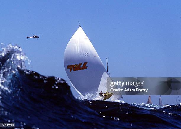 Wild Thing a Maxi Yacht is overtaken by a Jet Ski spectator craft, after the start of The Sydney to Hobart Yacht Race. Sydney, Australia. Mandatory...