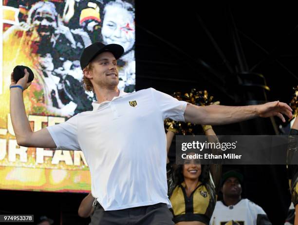 Jon Merrill of the Vegas Golden Knights throws T-shirts to the crowd as he is introduced at the team's "Stick Salute to Vegas and Our Fans" event at...