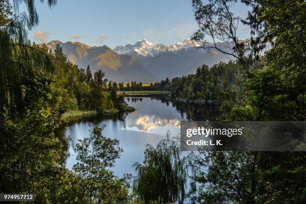 lake with mountain range in background, south island, new zealand - south westland bildbanksfoton och bilder