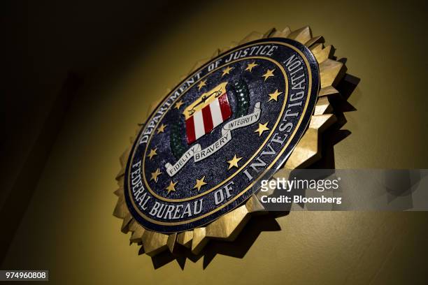 The seal of the Federal Bureau of Investigation hangs on a wall before a news conference at the FBI headquarters in Washington, D.C., U.S., on...