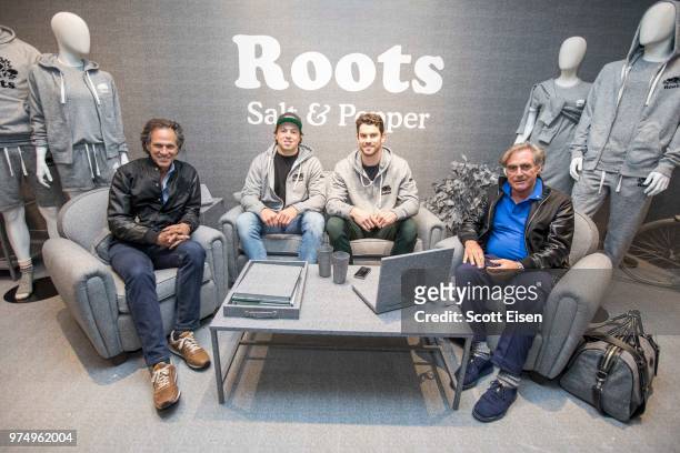 Boston Bruins players Charlie McAvoy and Adam McQuaid sit with Roots co-founders Don Green, left, and Michael Budman, right, at the Roots Newbury...