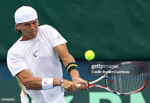 Peter Luczak of Australia plays a backhand duiring his match against Tsung-Hua Yang of Chinese Taipei during day three of the Davis Cup Asia-Oceania...