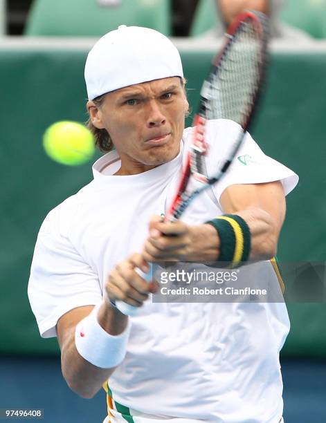 Peter Luczak of Australia plays a backhand duiring his match against Tsung-Hua Yang of Chinese Taipei during day three of the Davis Cup Asia-Oceania...