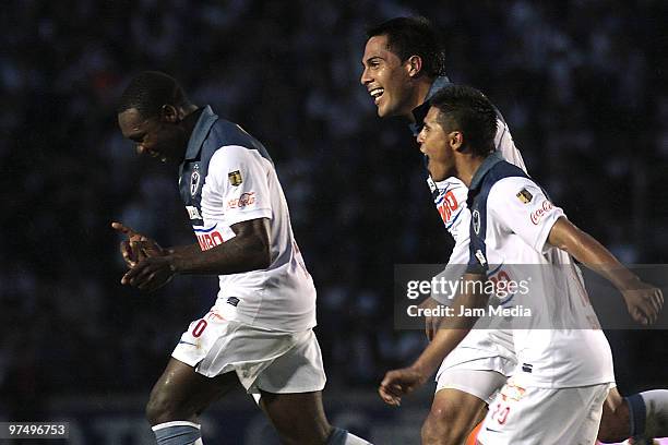 Players Walter Ayovi , Hector Morales and Oswaldo Martinez of Monterrey celebrate a scored goal during their match against Pachuca as part of 2010...