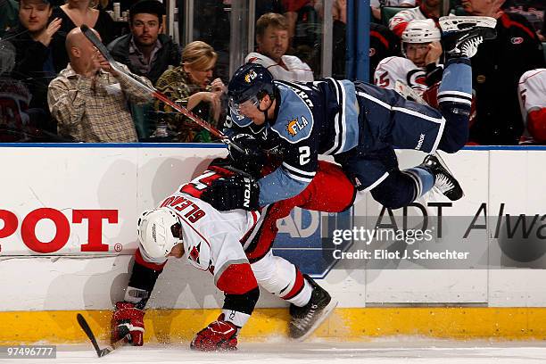 Keith Ballard of the Florida Panthers collides with Tim Gleason of the Carolina Hurricanes at the BankAtlantic Center on March 6, 2010 in Sunrise,...