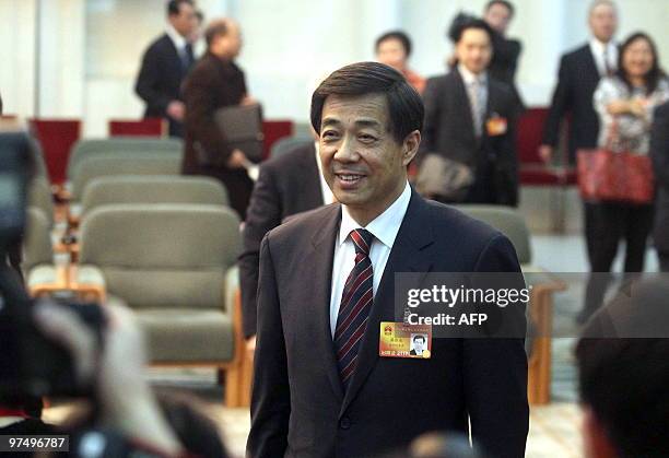 Bo Xilai, the charismatic head of China's Chongqing municipality, talks to reporters as he arrives for a meeting where he vowed to continue a...