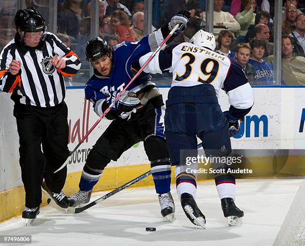 Steve Downie of the Tampa Bay Lightning battles against Tobias Enstrom of the Atlanta Thrashers for control of the puck during the first period at...