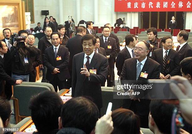 Bo Xilai , the charismatic head of China's Chongqing municipality, talks to reporters as he arrives for a meeting where he vowed to continue a...