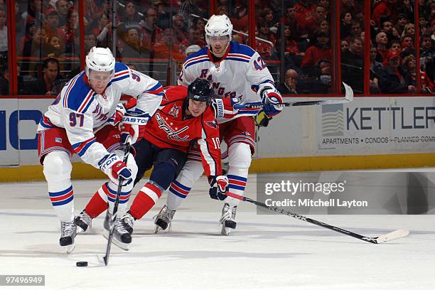 Matt Gilroy of the New York Rangers controls the puck during a NHL hockey game against Matt Bradley of the Washington Capitals on March 6, 2010 at...