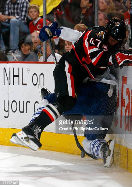 Zack Smith of the Ottawa Senators crushes Luke Schenn of the Toronto Maple Leafs in behind the net in a game at Scotiabank Place on March 6, 2010 in...