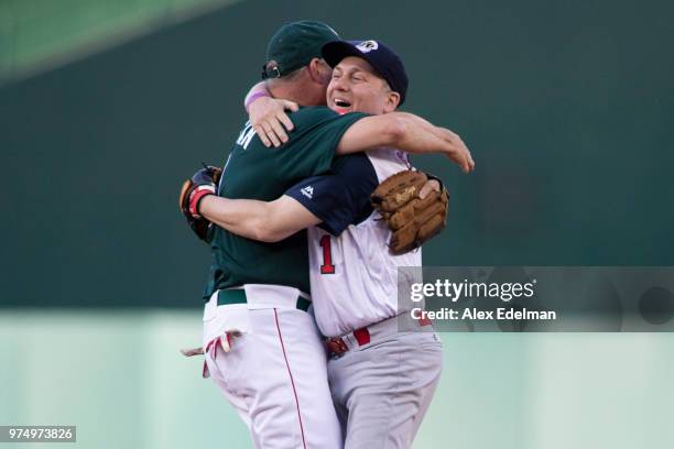 Rep Steve Scalise celebrates with Rep Jeff Duncan after making a play to first base resulting in an out after fielding a ground ball on the first...