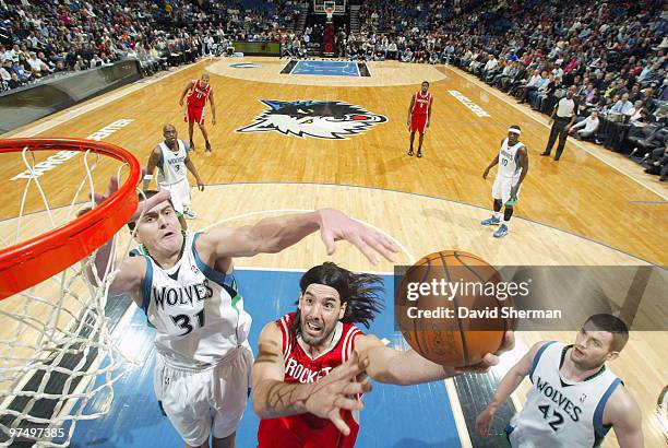 Luis Scola of the Houston Rockets goes to the basket against Darko Milicic of the Minnesota Timberwolves during the game on March 6, 2010 at the...