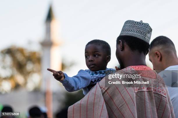 Yound boy and his father wait outside Lakemba Mosque on June 15, 2018 in Sydney, Australia. The religious Eid al-Fitr festival is celebrated for...