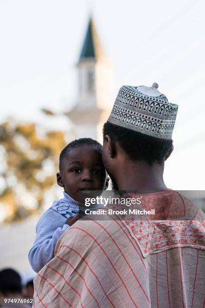 Yound boy and his father wait outside Lakemba Mosque on June 15, 2018 in Sydney, Australia. The religious Eid al-Fitr festival is celebrated for...