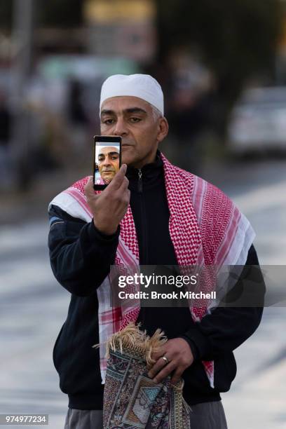 Man takes video on his phone at Lakemba Mosque on June 15, 2018 in Sydney, Australia. The religious Eid al-Fitr festival is celebrated for three days...