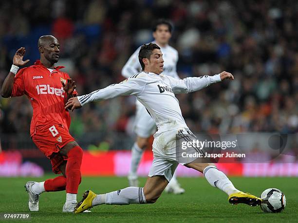 Cristiano Ronaldo of Real Madrid duels for the ball with Arouna Kone of Sevilla during the La Liga match between Real Madrid and Sevilla at the...