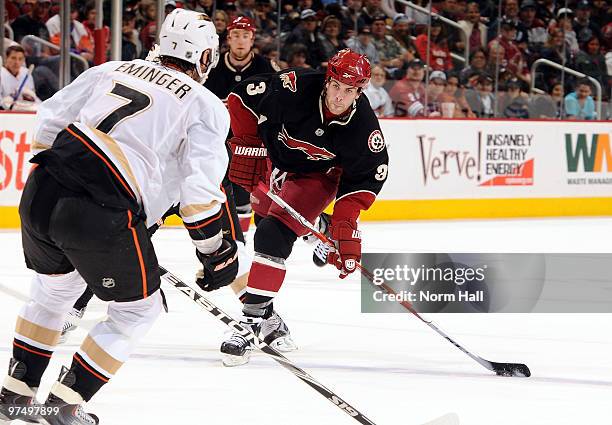 Keith Yandle of the Phoenix Coyotes shoots the puck past Steve Eminger of the Anaheim Ducks on March 6, 2010 at Jobing.com Arena in Glendale, Arizona.