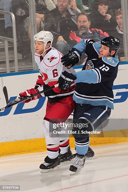 Byron Bitz of the Florida Panthers tangles with Tim Gleason of the Carolina Hurricanes at the BankAtlantic Center on March 6, 2010 in Sunrise,...