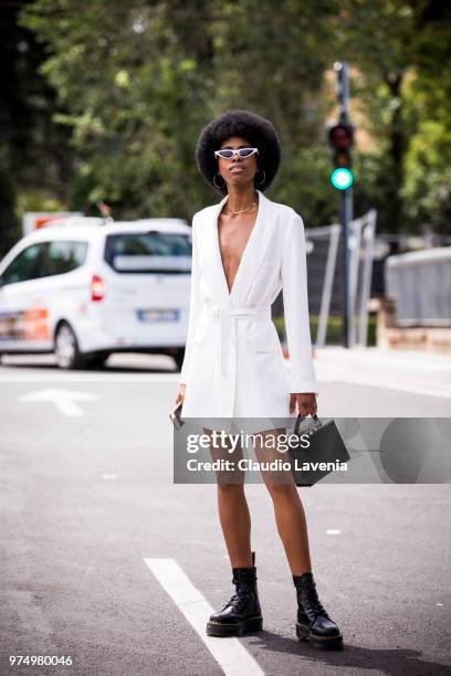 Guest, wearing a white blazer and combat boots, is seen during the 94th Pitti Immagine Uomo at Fortezza Da Basso on June 14, 2018 in Florence, Italy.