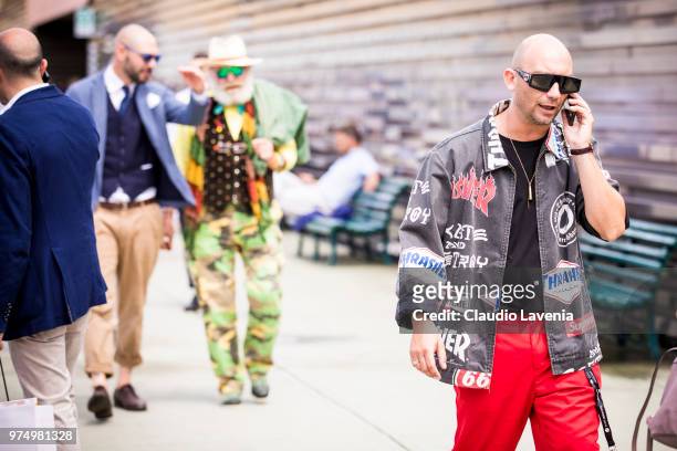 Guest, wearing Gucci sunglasses, denim Thrasher jacket and red pants, is seen during the 94th Pitti Immagine Uomo at Fortezza Da Basso on June 14,...