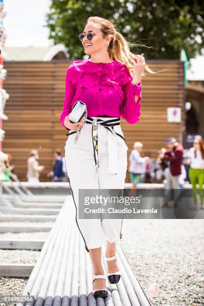 Giulia Gaudino, wearing purple shirt, black and white pants and Preventi by Giulia Gaudino shoes, is seen during the 94th Pitti Immagine Uomo at...