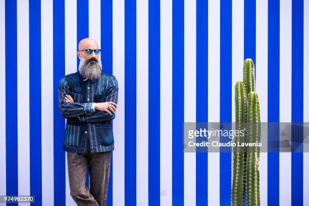 Felpastyle, wearing striped denim shirt and brown pants, is seen during the 94th Pitti Immagine Uomo at Fortezza Da Basso on June 14, 2018 in...