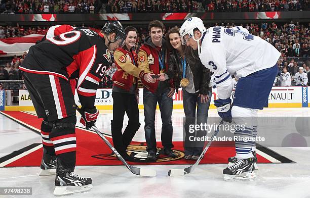 Olympic gold medalists Tessa Virtue, Scott Moir and Jennifer Botterill drop the puck for a ceremonial faceoff with Jason Spezza of the Ottawa...