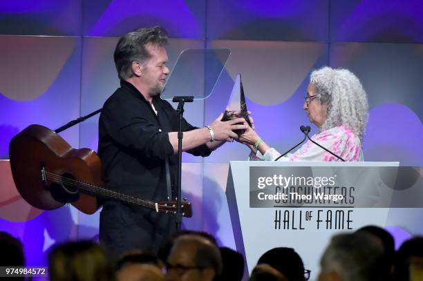 Songwriters Hall of Fame Inductee John Mellencamp accepts award from Nora Guthrie onstage during the Songwriters Hall of Fame 49th Annual Induction...