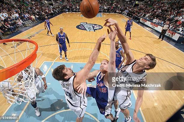 Mehmet Okur and Andrei Kirilenko of the Utah Jazz attempt to block a shot by Chris Kaman of the Los Angeles Clippers at EnergySolutions Arena on...