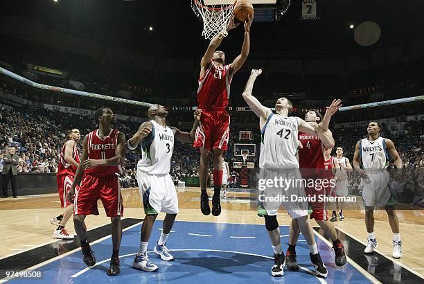 Jared Jeffries of the Houston Rockets gets the rebound against Damien Wilkins and Kevin Love of the Minnesota Timberwovles during the game on March...