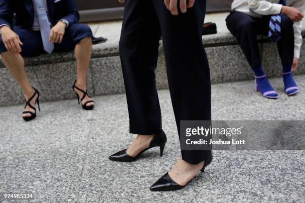 Male attorneys walk in women's high heel shoes to raise awareness of sexual assault against women on June 14, 2018 in Chicago, Illinois. Just under a...
