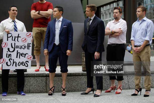 Male attorneys stand in women's high heel shoes to raise awareness of sexual assault against women on June 14, 2018 in Chicago, Illinois. Just under...