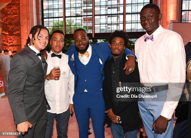 Up2Us Sports Coach and 2018 Coach of the Year Award Winner Tayquan Faulkner poses with members of his football team during the 2018 Up2Us Sports Gala...