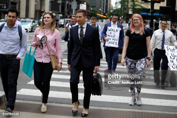 Attorney Jonathan Mraunac walks in women's high heel shoes to raise awareness of sexual assault against women on June 14, 2018 in Chicago, Illinois....