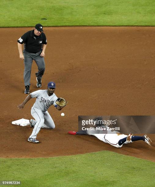 Second baseman Jose Pirela of the San Diego Padres receives a throw and eventually tags out second baseman Ozzie Albies of the Atlanta Braves on a...