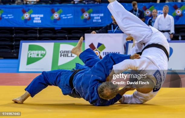 Wolfgang Loeffler of Germany throws Giovanni Lucantoni of Italy with a stomach throw for ippon to win their u73kg M8 contest on his way to the gold...