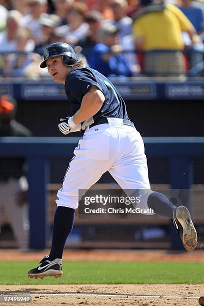 Eric Byrnes of the Seattle Mariners runs to first base against the San Francisco Giants during a spring training game at Peoria Sports Complex on...