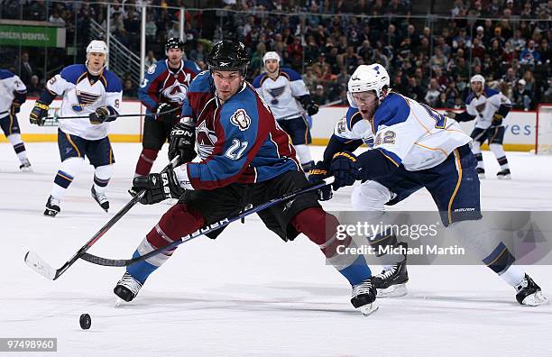 Scott Hannan of the Colorado Avalanche skates against David Backes of the St. Louis Blues at the Pepsi Center on March 6, 2010 in Denver, Colorado.