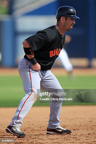 Aaron Rowand of the San Francisco Giants runs between bases against the Seattle Mariners during a spring training game at Peoria Sports Complex on...