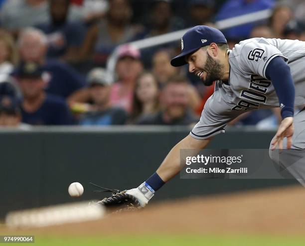 First baseman Eric Hosmer of the San Diego Padres can't come up with an errant throw by pitcher Adam Cimber to score a run in the eighth inning...