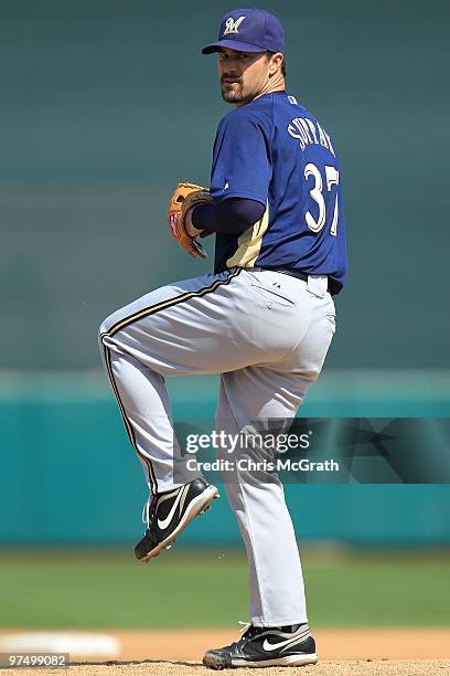 Jeff Suppan of the Milwaukee Brewers throws warm up pitches against the San Francisco Giants during a spring training game at Scottsdale Stadium on...