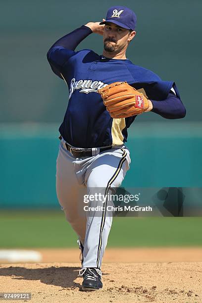 Jeff Suppan of the Milwaukee Brewers throws warm up pitches against the San Francisco Giants during a spring training game at Scottsdale Stadium on...