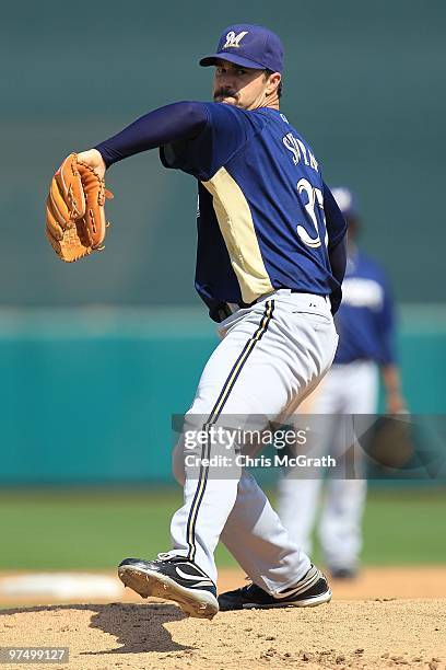 Jeff Suppan of the Milwaukee Brewers throws warm up pitches against the San Francisco Giants during a spring training game at Scottsdale Stadium on...